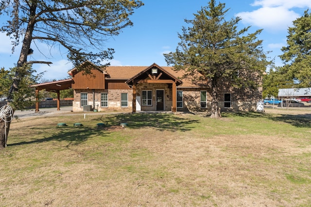 view of front of house with brick siding and a front lawn