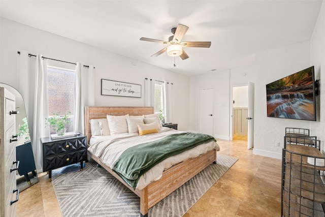 bedroom featuring arched walkways, baseboards, and ceiling fan