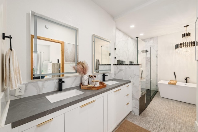 bathroom with double vanity, a soaking tub, a marble finish shower, and a sink