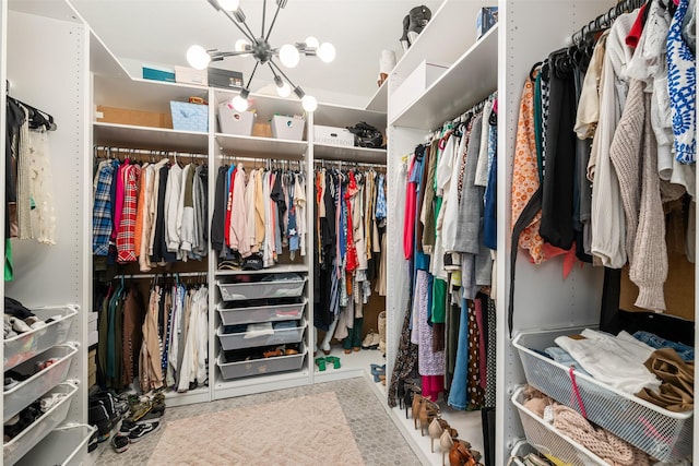 spacious closet with a notable chandelier
