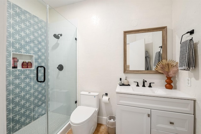 bathroom featuring vanity, toilet, and a stall shower
