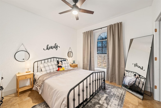 bedroom with baseboards and ceiling fan