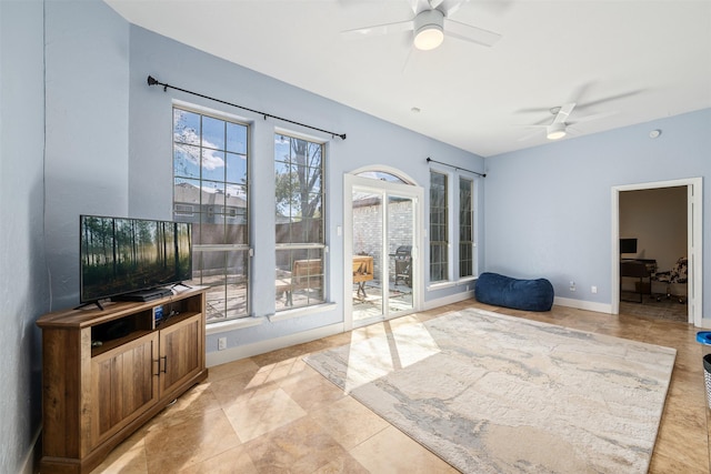 interior space featuring a ceiling fan and baseboards