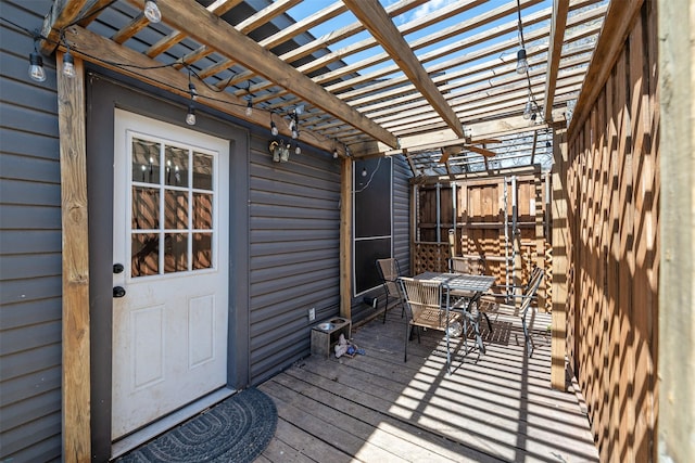 wooden deck with outdoor dining space and a pergola