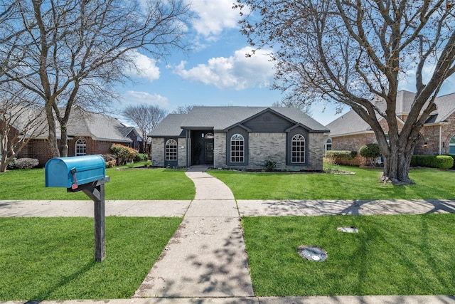7829 Creekview Dr, Frisco, TX 75034 - view of front of property featuring a front lawn, brick siding, and roof with shingles