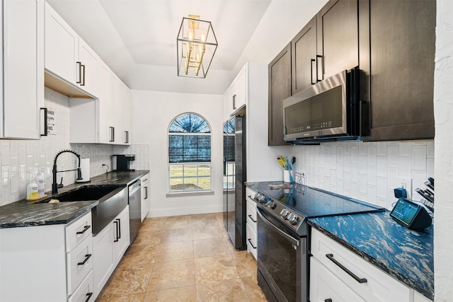 kitchen with a sink, decorative backsplash, baseboards, and appliances with stainless steel finishes