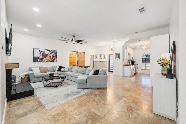 living room featuring visible vents, baseboards, ceiling fan, recessed lighting, and arched walkways