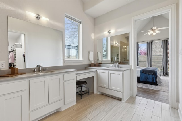 bathroom featuring a sink, two vanities, and ceiling fan
