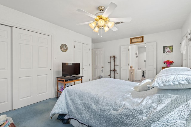 bedroom with visible vents, two closets, carpet, and a ceiling fan