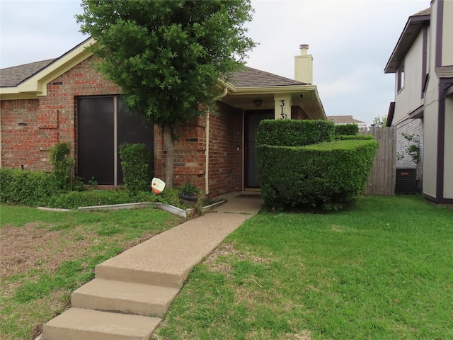 313 Conger Dr, Mesquite, TX 75149 - view of front of house with brick siding, a shingled roof, a chimney, and a front yard