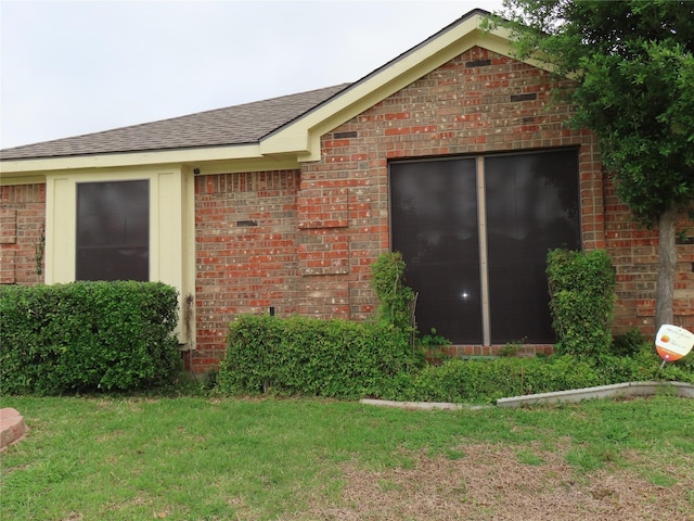 313 Conger Dr, Mesquite, TX 75149 - view of side of home with brick siding, a shingled roof, and a lawn