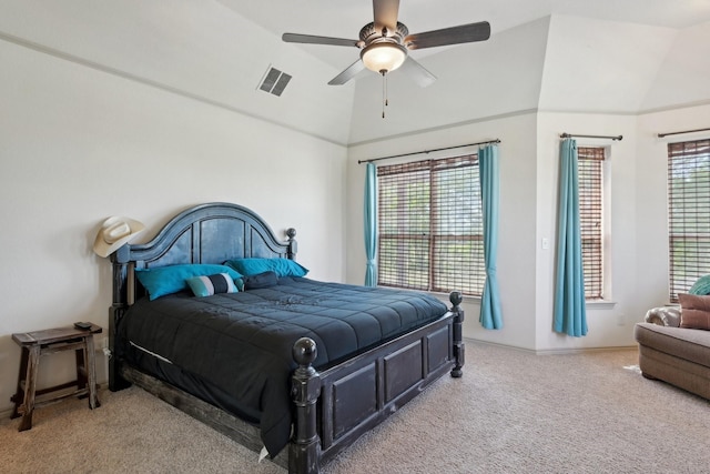carpeted bedroom with visible vents, vaulted ceiling, and ceiling fan