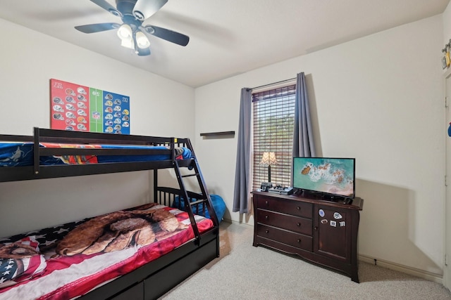 carpeted bedroom featuring baseboards and a ceiling fan