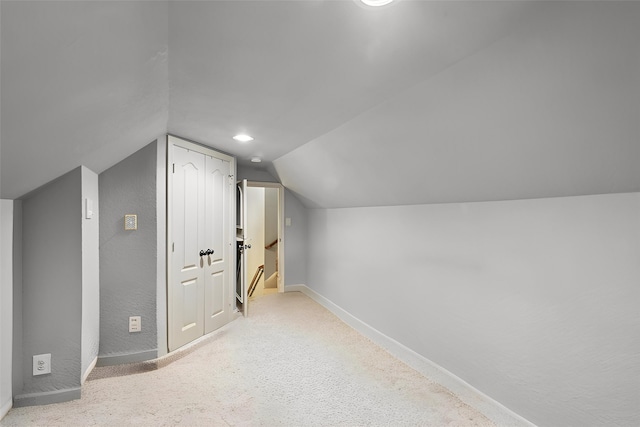 additional living space featuring baseboards and lofted ceiling