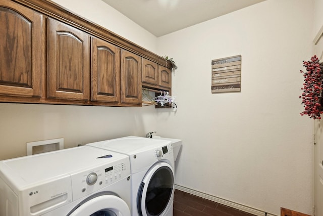 laundry room with washer and dryer, dark wood-style floors, baseboards, and cabinet space
