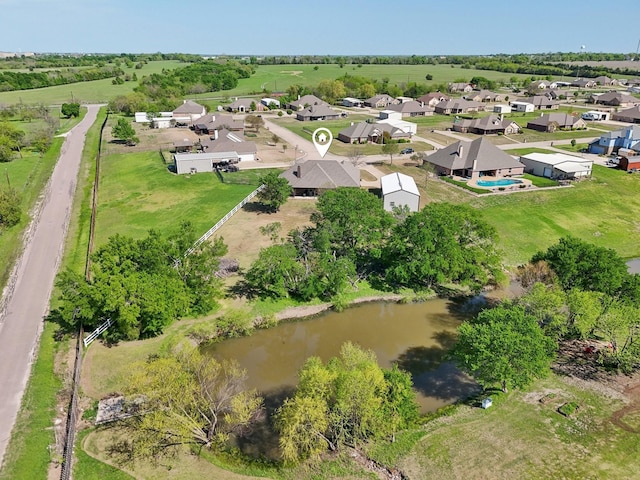 drone / aerial view with a residential view and a water view