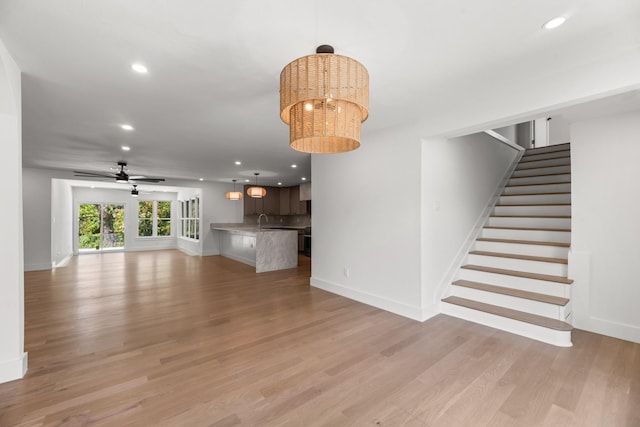 9805 Bluff Dale Dr, Dallas, TX 75218 - unfurnished living room with light wood-type flooring, baseboards, stairway, and recessed lighting