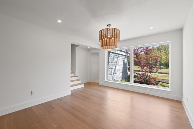9805 Bluff Dale Dr, Dallas, TX 75218 - unfurnished room with a chandelier, light wood-style floors, recessed lighting, and stairway