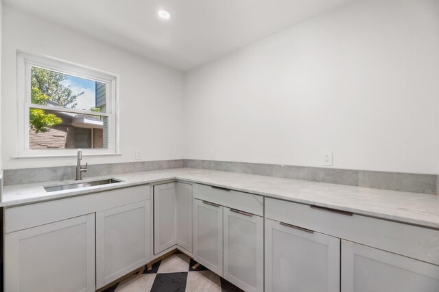9805 Bluff Dale Dr, Dallas, TX 75218 - kitchen featuring white cabinets, recessed lighting, a sink, and light stone counters