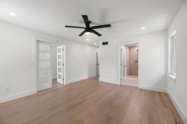 9805 Bluff Dale Dr, Dallas, TX 75218 - unfurnished bedroom with a spacious closet, recessed lighting, and light wood-type flooring