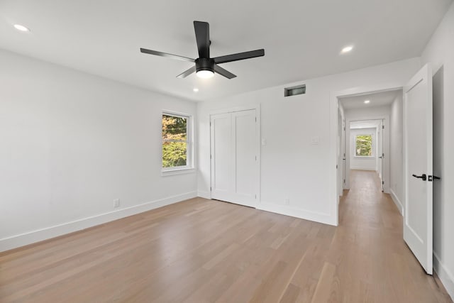 9805 Bluff Dale Dr, Dallas, TX 75218 - unfurnished bedroom with visible vents, baseboards, light wood-type flooring, and multiple windows