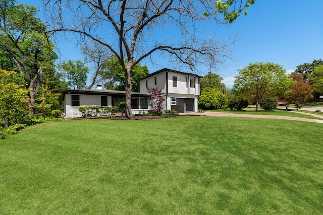 9805 Bluff Dale Dr, Dallas, TX 75218 - view of front facade featuring driveway, a garage, and a front lawn