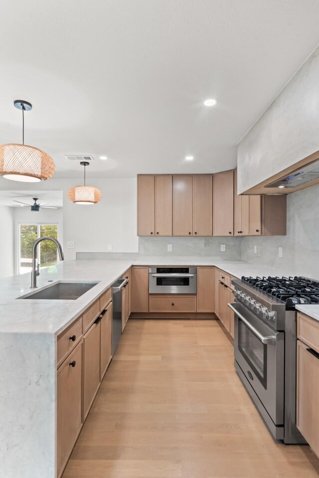 9805 Bluff Dale Dr, Dallas, TX 75218 - kitchen featuring visible vents, a sink, a peninsula, light brown cabinetry, and stainless steel appliances
