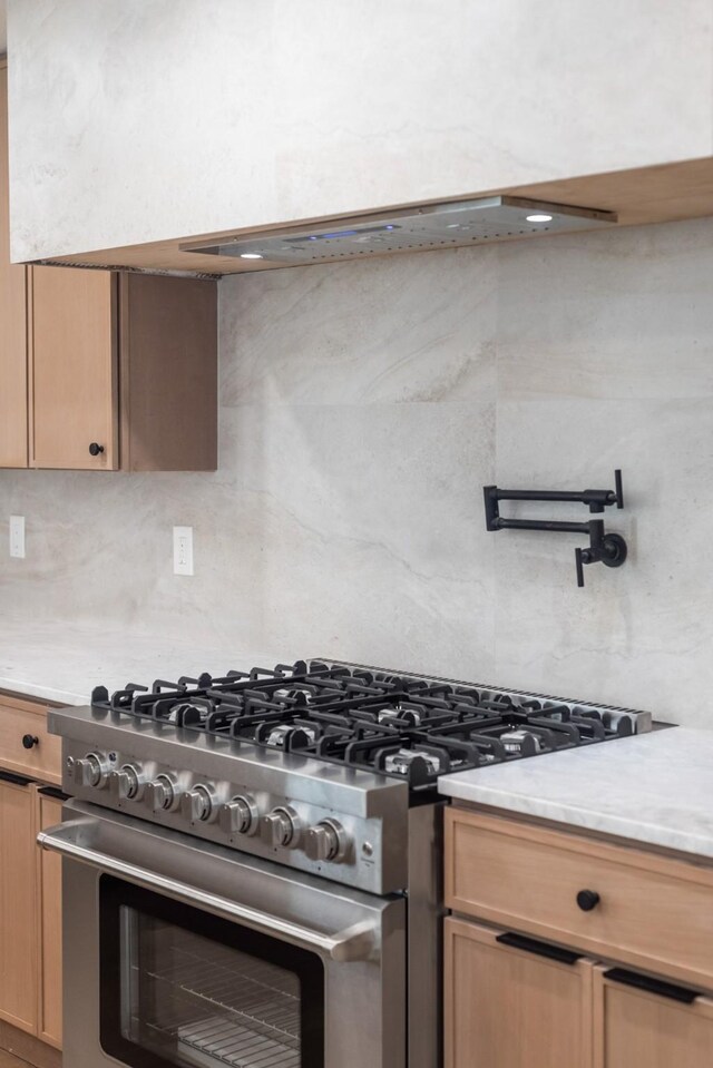 9805 Bluff Dale Dr, Dallas, TX 75218 - kitchen with stainless steel range, light countertops, and tasteful backsplash