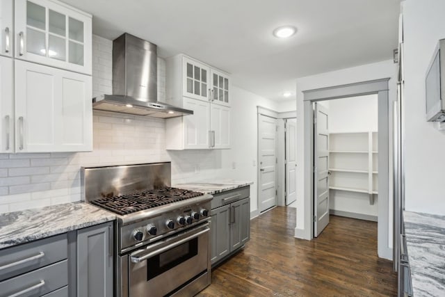 4108 Desert Garden Dr, Plano, TX 75093 - kitchen with high end stove, wall chimney exhaust hood, gray cabinets, white cabinets, and dark wood-style flooring