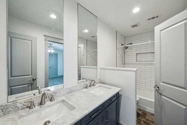 4108 Desert Garden Dr, Plano, TX 75093 - full bathroom with toilet, double vanity, recessed lighting, shower / bathtub combination, and wood finished floors