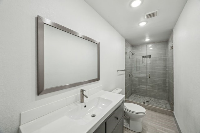 4108 Desert Garden Dr, Plano, TX 75093 - full bath featuring toilet, a shower stall, vanity, recessed lighting, and wood finished floors