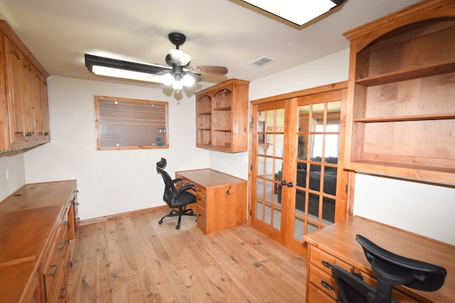 office space with a ceiling fan, visible vents, baseboards, light wood-style flooring, and french doors