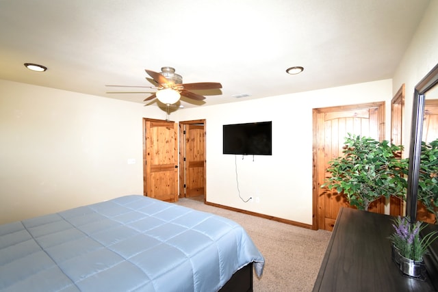 carpeted bedroom featuring visible vents, baseboards, and a ceiling fan