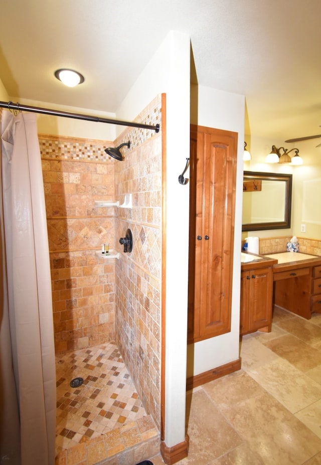bathroom with vanity and a tile shower