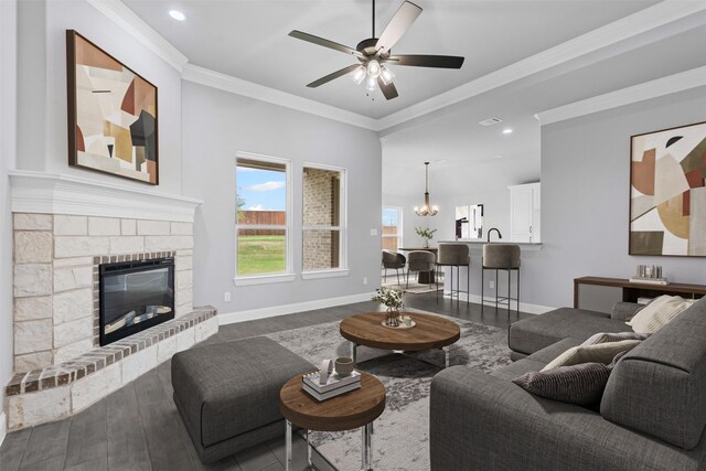 700 Jameson, Springtown, TX 76082 - unfurnished living room featuring ornamental molding, ceiling fan with notable chandelier, baseboards, dark wood-type flooring, and a glass covered fireplace