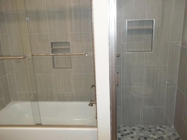 full bathroom featuring a bathtub and a tile shower