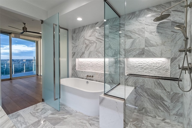 3130 N Harwood St Unit 1404, Dallas, TX 75201 - full bathroom with a marble finish shower, a freestanding bath, recessed lighting, and tile walls