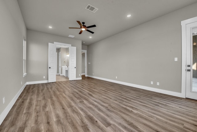 unfurnished bedroom with recessed lighting, wood finished floors, visible vents, and baseboards