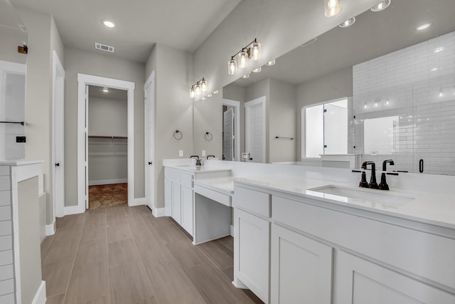 bathroom with visible vents, recessed lighting, a shower stall, a spacious closet, and vanity