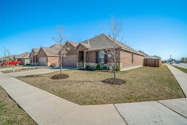 view of front of house featuring driveway, a front lawn, a residential view, a garage, and brick siding