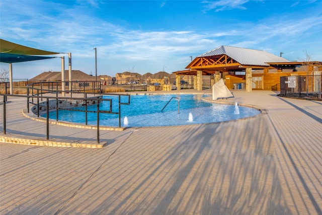 view of pool featuring fence