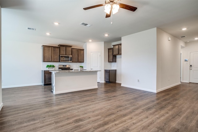 kitchen featuring visible vents, tasteful backsplash, stainless steel appliances, ceiling fan, and dark wood-style flooring