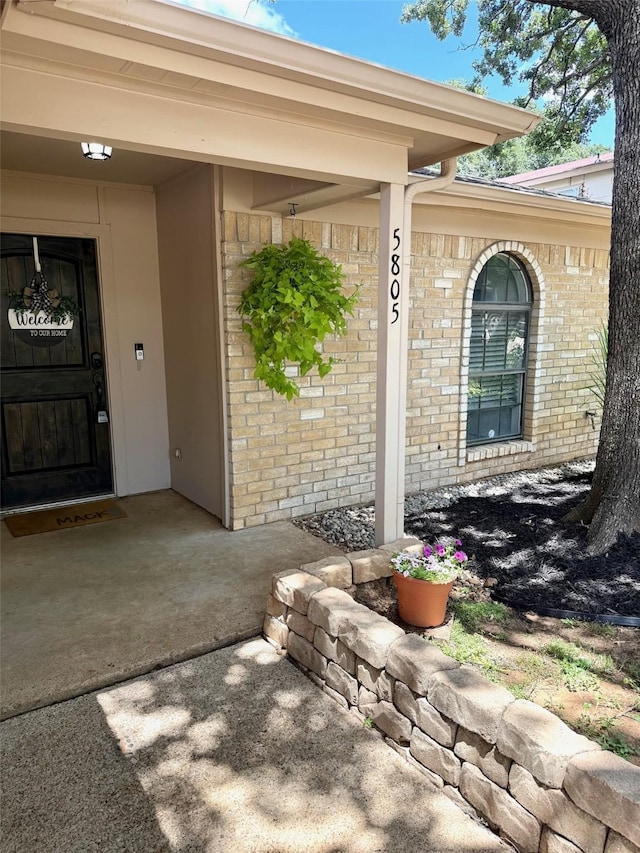 5805 Trail Crest Dr, Arlington, TX 76017 - view of exterior entry featuring brick siding