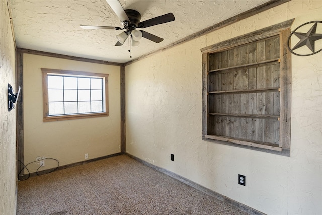 empty room featuring carpet, a textured ceiling, a ceiling fan, a textured wall, and baseboards