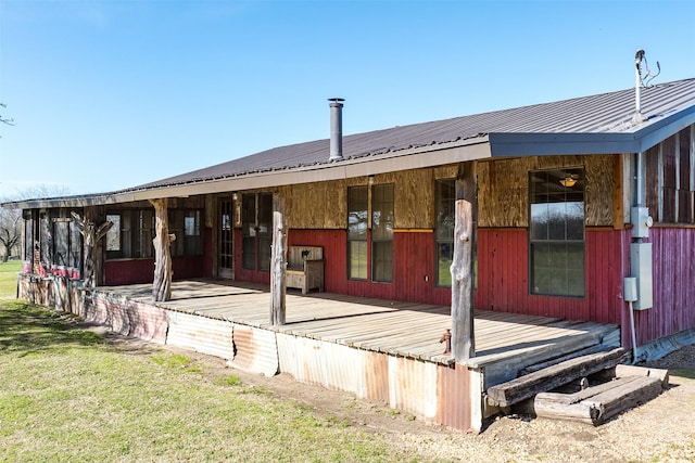 back of property with metal roof and a deck