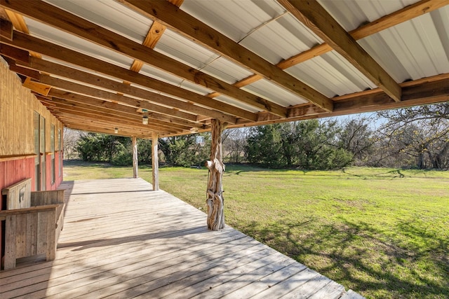 wooden terrace featuring a lawn