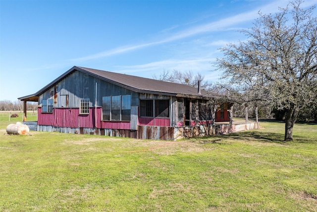 view of front of home featuring metal roof and a front yard