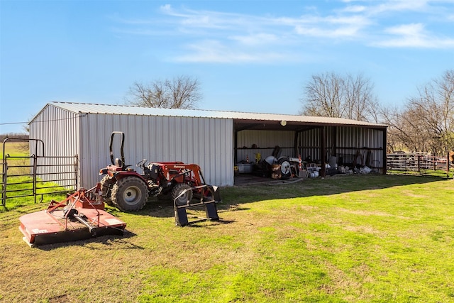view of pole building featuring a yard, a detached carport, and fence