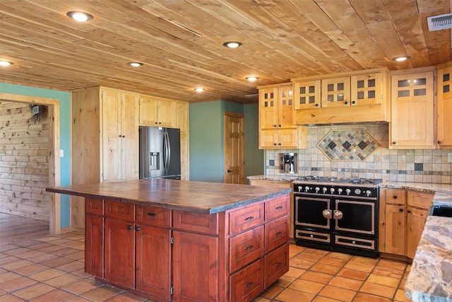 kitchen featuring visible vents, stainless steel refrigerator with ice dispenser, wooden ceiling, range with two ovens, and backsplash