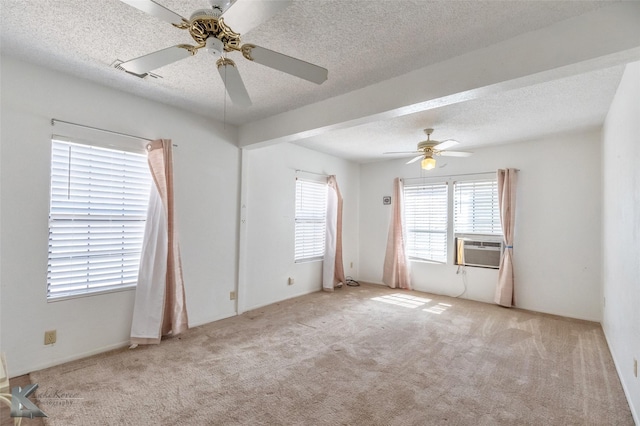 carpeted empty room with cooling unit, a textured ceiling, and a ceiling fan